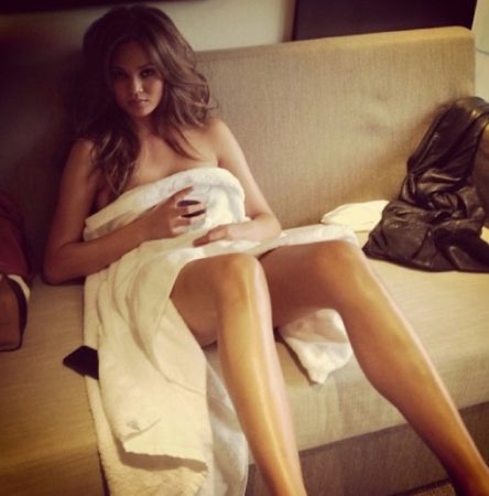 Chrissy Teigen wearing towel with wine